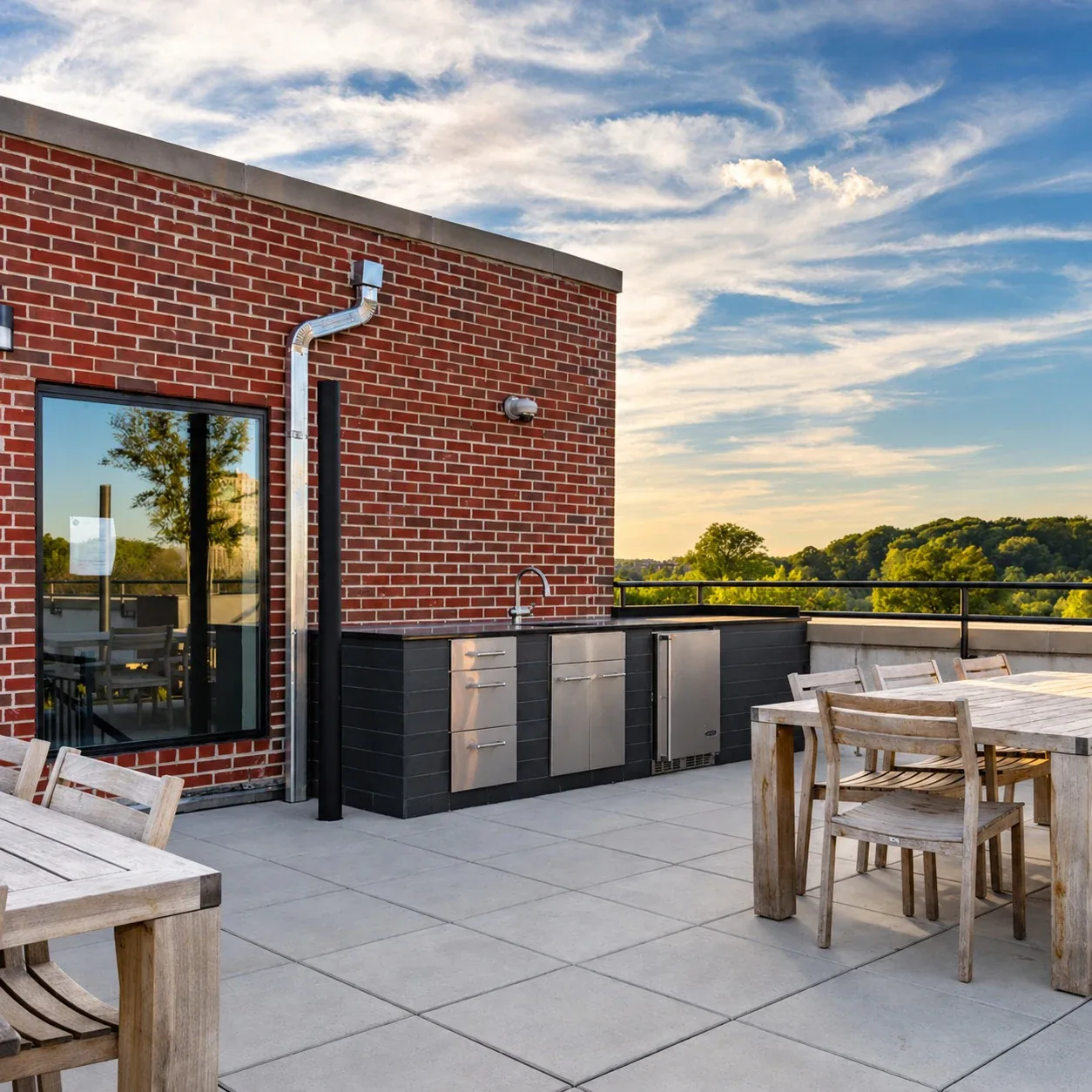 123 Parkside Avenue: Rooftop patio with dining furniture and an outdoor counter beside a brick wall