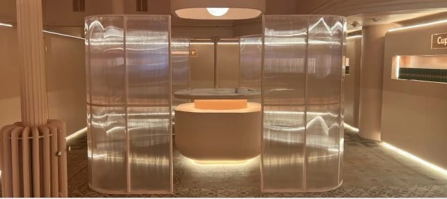 Ansa Coffee: Curved translucent screens surrounding an illuminated cafe counter