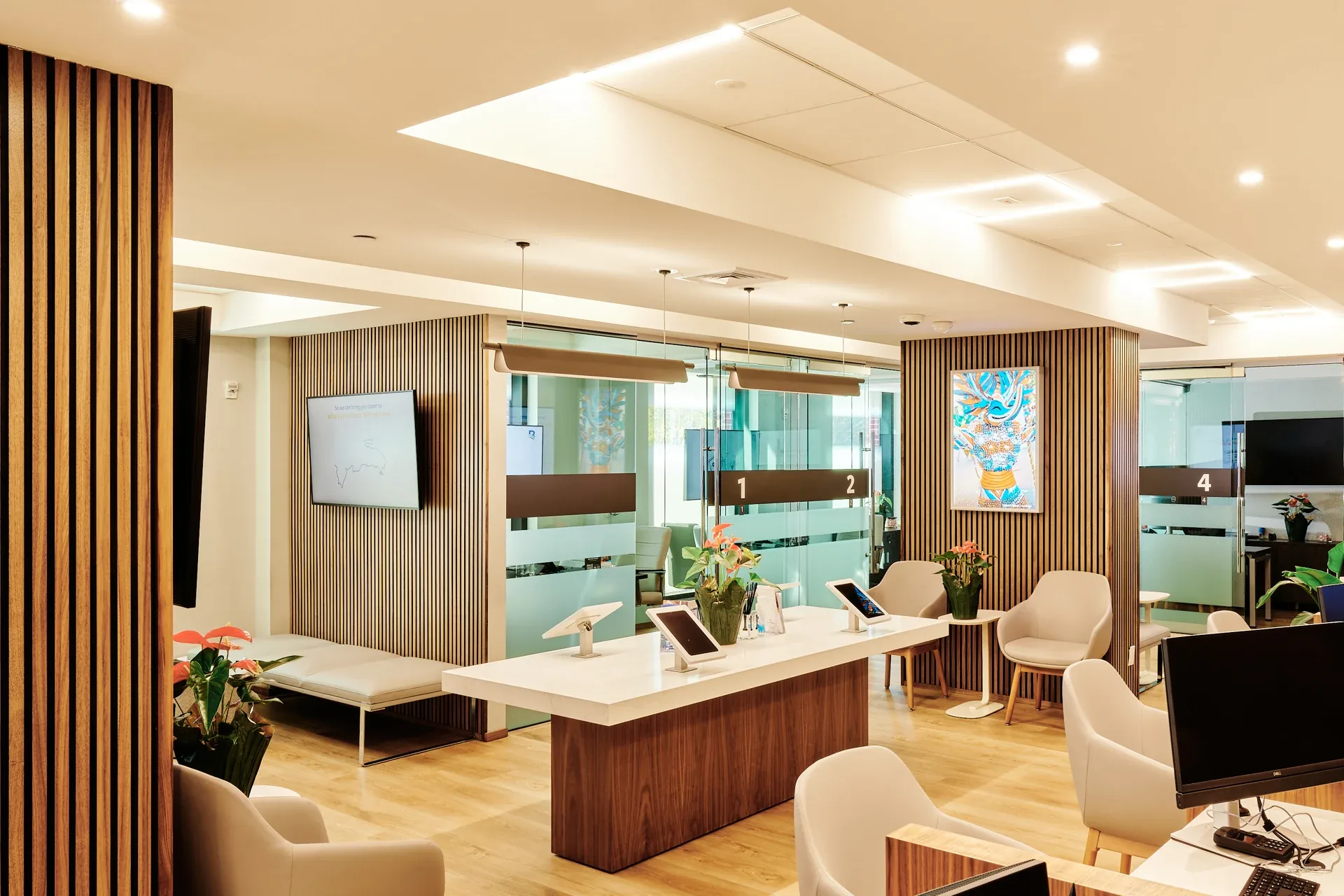 Banreservas: Bank interior with wood-slat partitions, glass offices and a central tablet counter