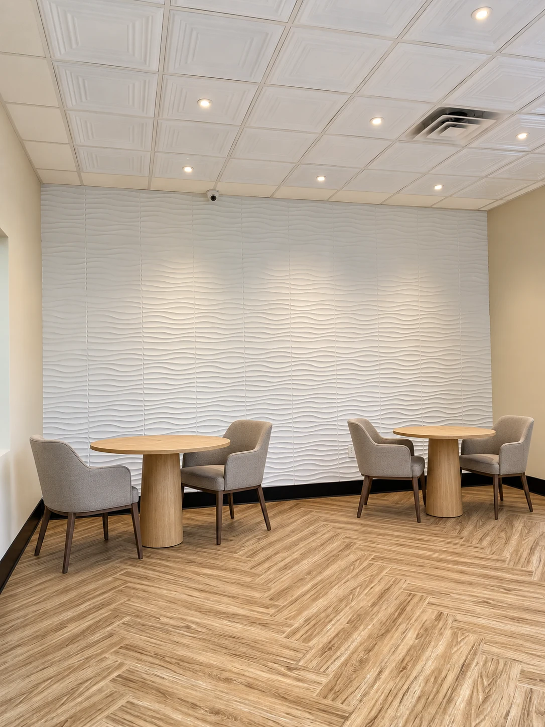 Generations Plus: Round tables and upholstered chairs beside a textured white feature wall