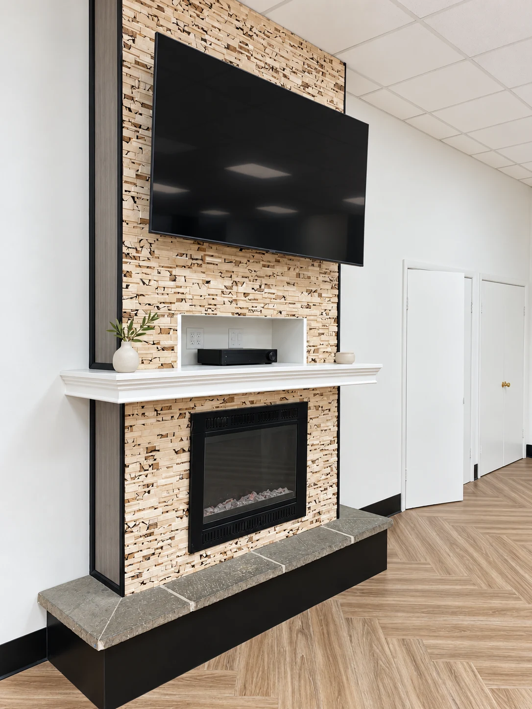 Generations Plus: Stone-faced fireplace with a white mantel and wall-mounted television