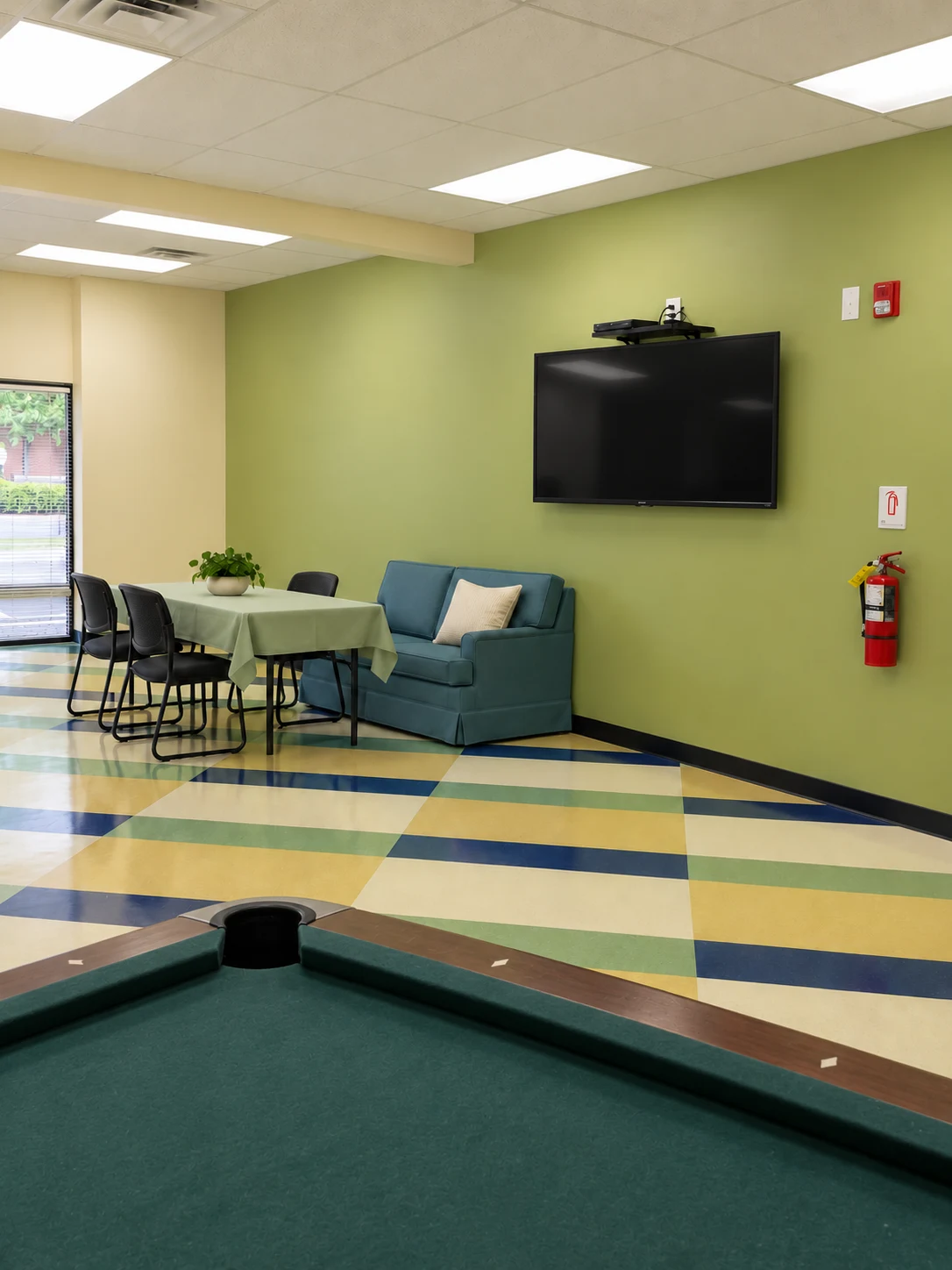 Generations Plus: Recreation area with a pool table, television, and patterned flooring