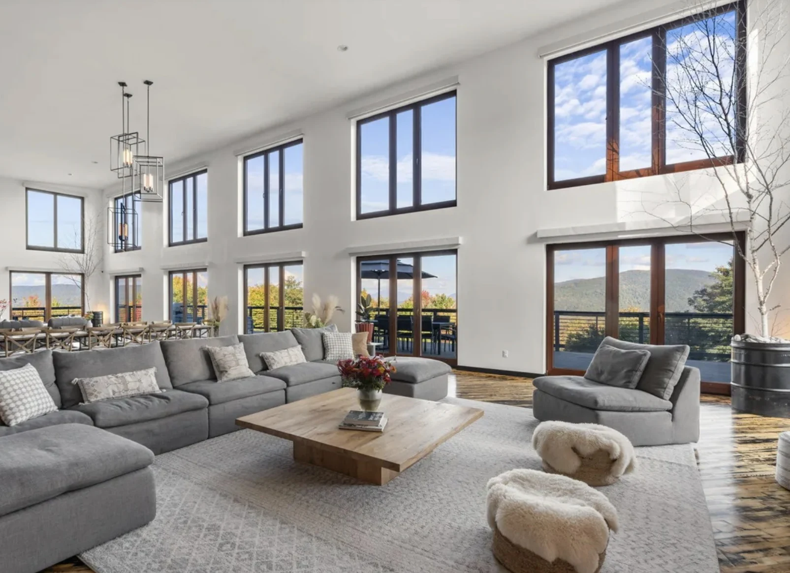 Le Chabanais: Double-height lounge with gray seating, tall windows and mountain views
