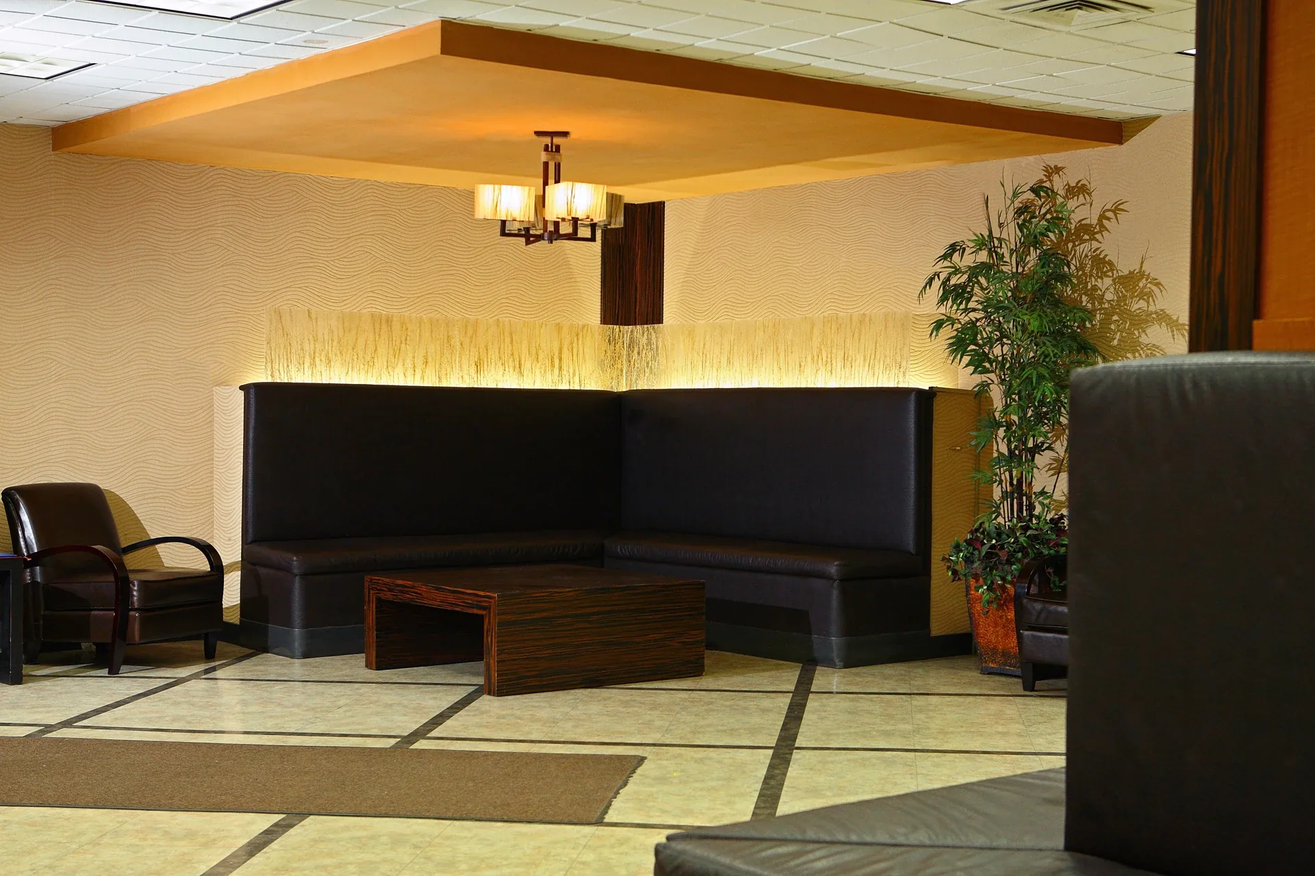 Newark Health & Extended Care: Lobby seating with a high-backed corner bench and illuminated decorative panels