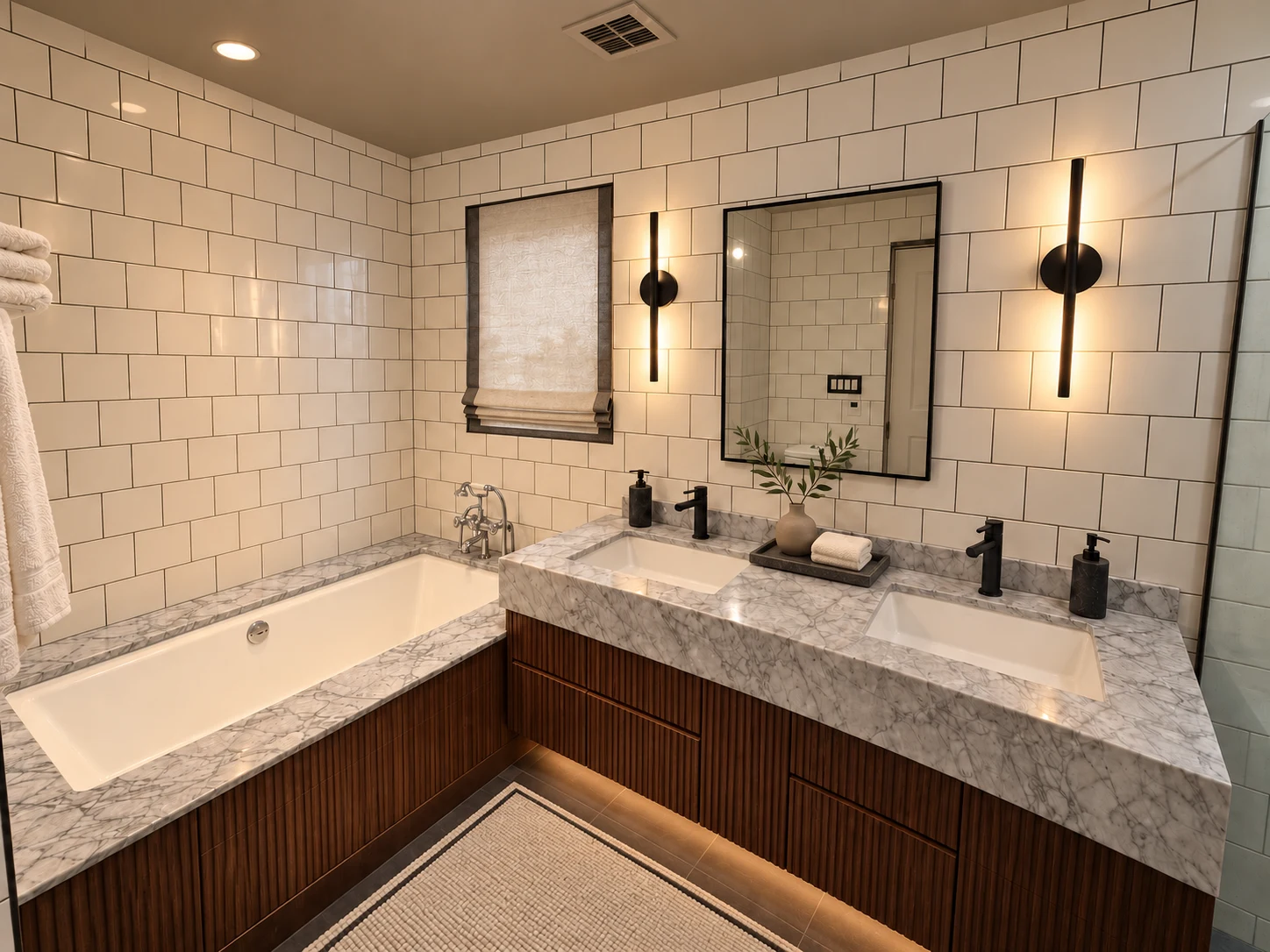 Residential Interiors: Bathroom with a double-sink vanity, inset bathtub, white tile and dark fixtures