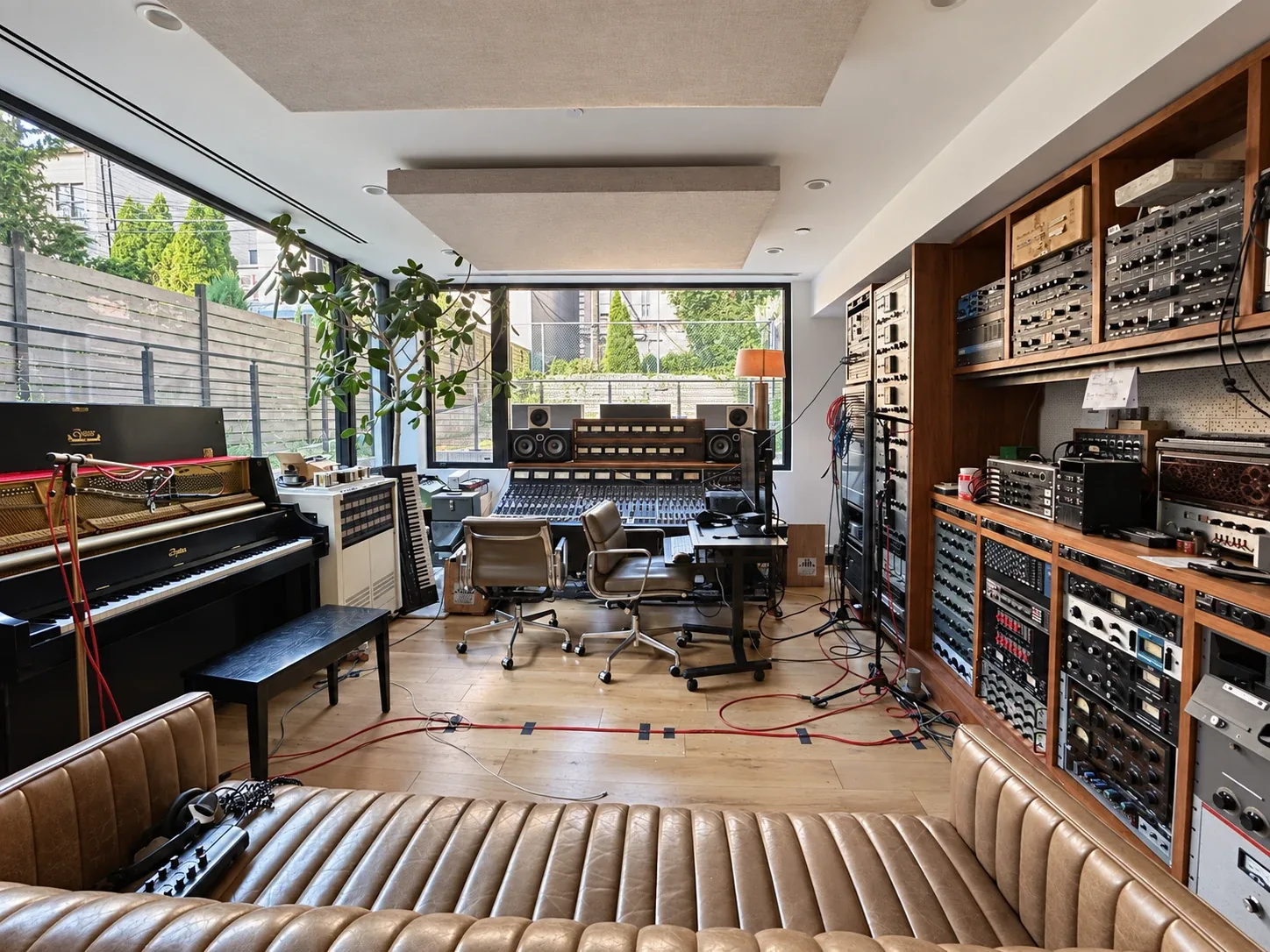 Thump: Recording studio with mixing console, equipment racks, upright piano and lounge seating