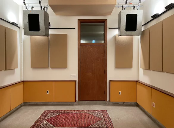 Thump: Studio interior with acoustic wall panels, suspended enclosures and a patterned rug