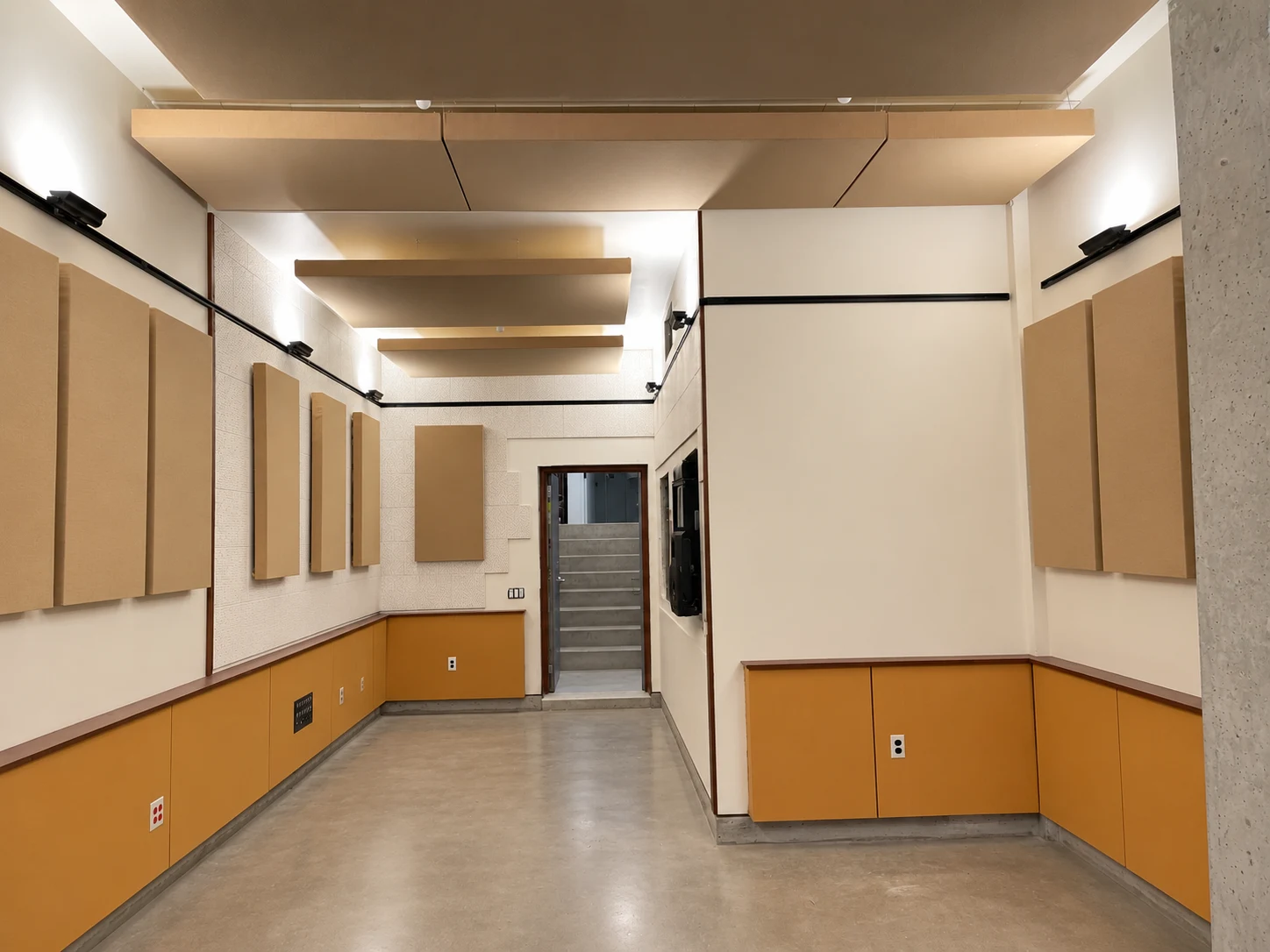 Thump: Studio interior with acoustic wall panels, ceiling baffles and yellow lower wall panels